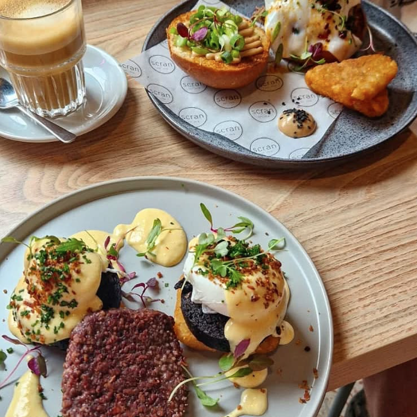 brunch food on table with eggs Stornaway, hash browns, square sausage, and a coffee